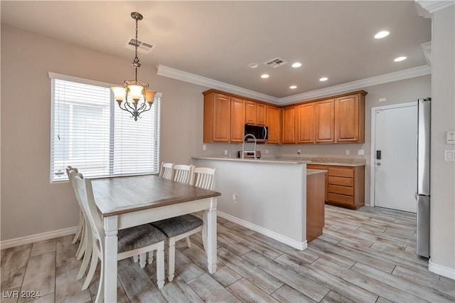 kitchen with ornamental molding, appliances with stainless steel finishes, decorative light fixtures, and kitchen peninsula