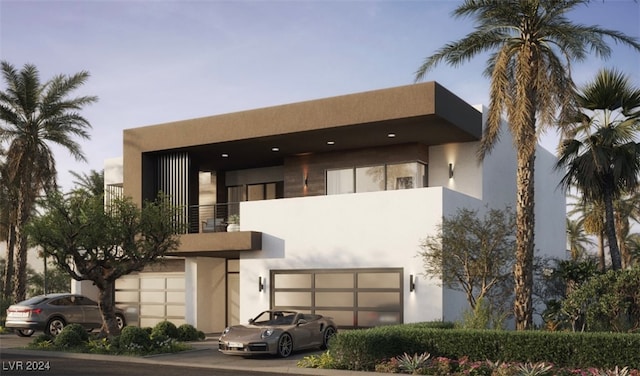 view of front facade featuring a garage and a balcony