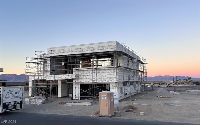 outdoor building at dusk with a mountain view