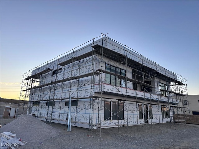 view of outdoor building at dusk