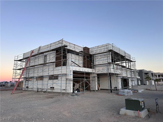 view of outdoor building at dusk