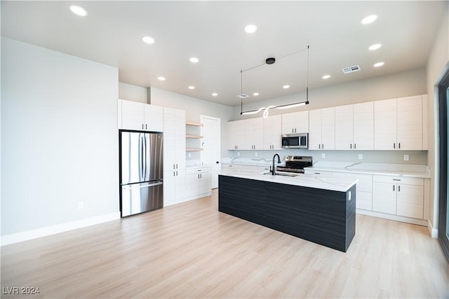 kitchen featuring an island with sink, open shelves, appliances with stainless steel finishes, modern cabinets, and visible vents