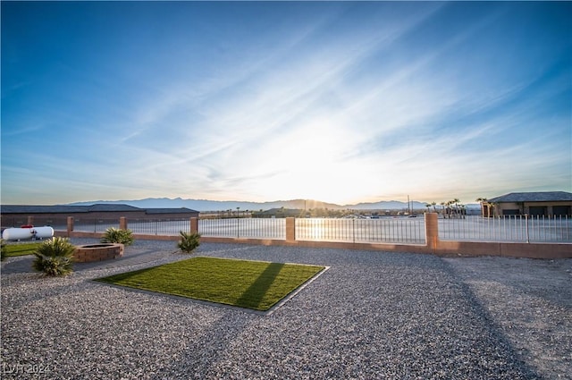 view of yard with a mountain view and fence