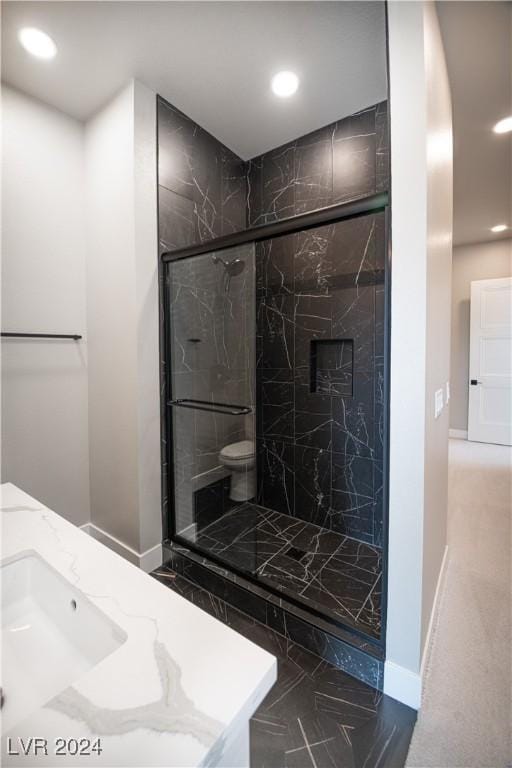 full bath featuring marble finish floor, baseboards, toilet, and a marble finish shower