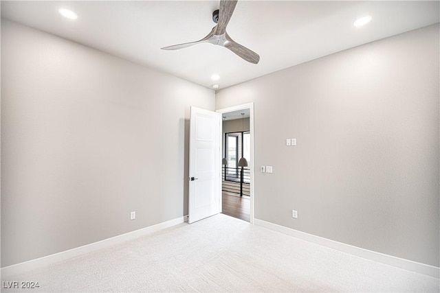 carpeted spare room featuring baseboards, recessed lighting, and a ceiling fan