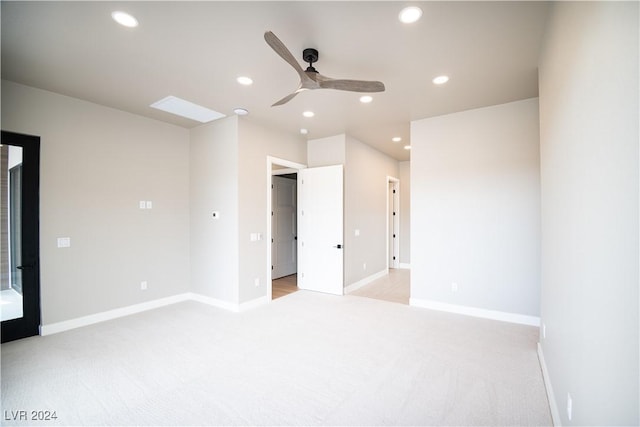unfurnished bedroom featuring light carpet, baseboards, and recessed lighting