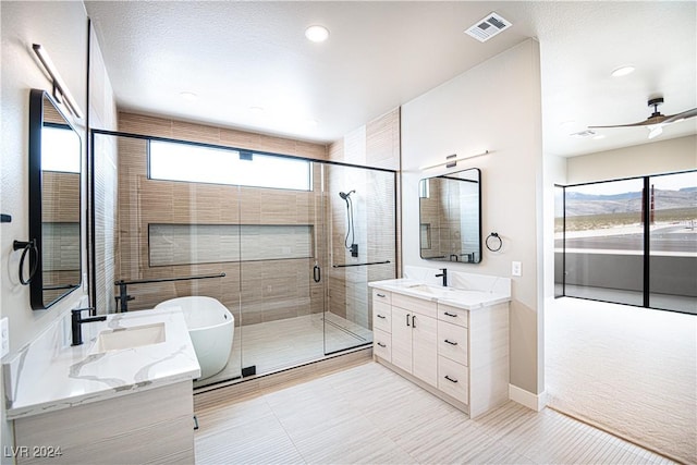 full bath featuring a sink, a shower stall, two vanities, and visible vents
