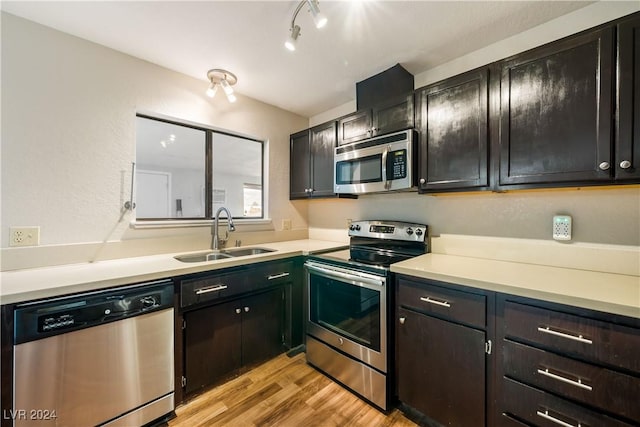 kitchen featuring sink, stainless steel appliances, and light wood-type flooring