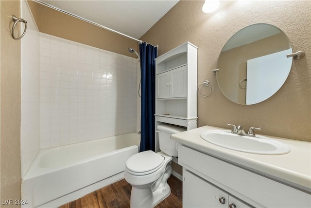 full bathroom featuring hardwood / wood-style flooring, vanity, shower / bath combo with shower curtain, and toilet