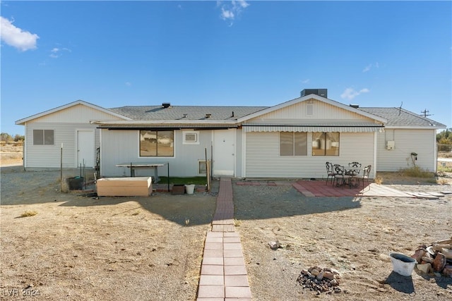 back of property with a patio