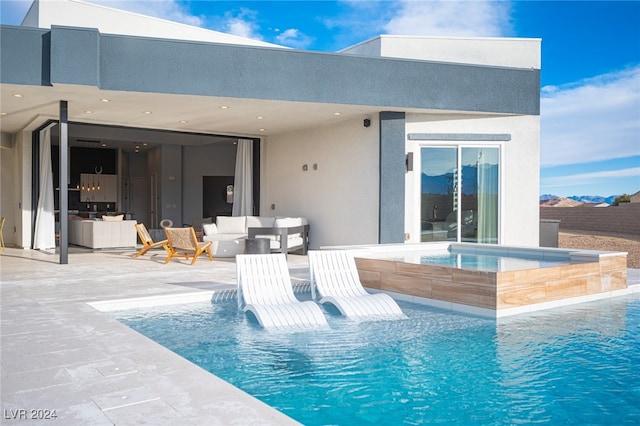 view of pool with a patio area, an in ground hot tub, and outdoor lounge area