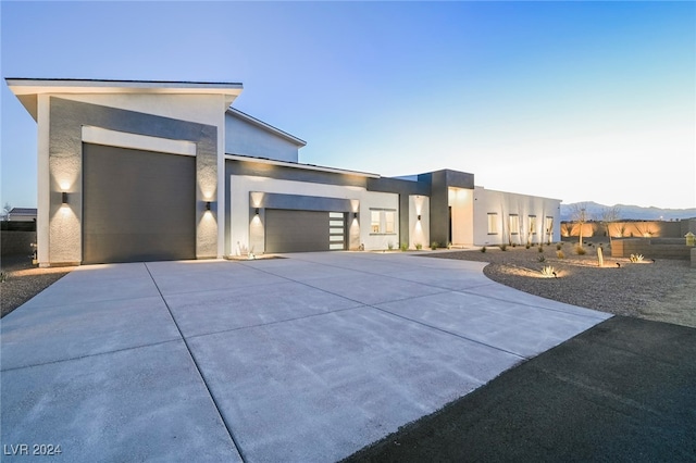 contemporary house with a mountain view and a garage