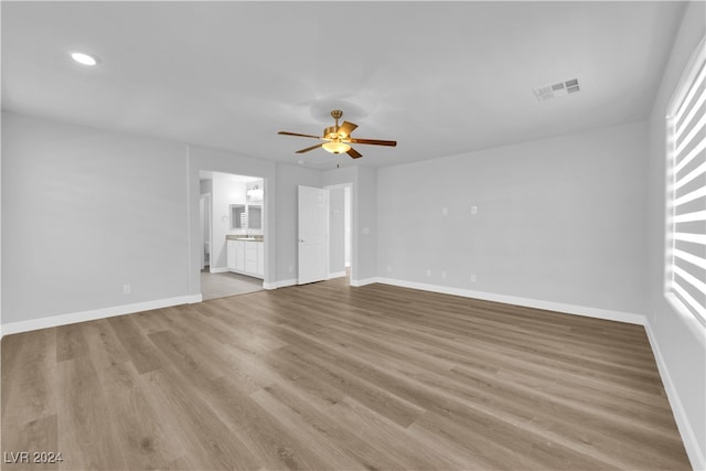 unfurnished living room with ceiling fan and light hardwood / wood-style flooring