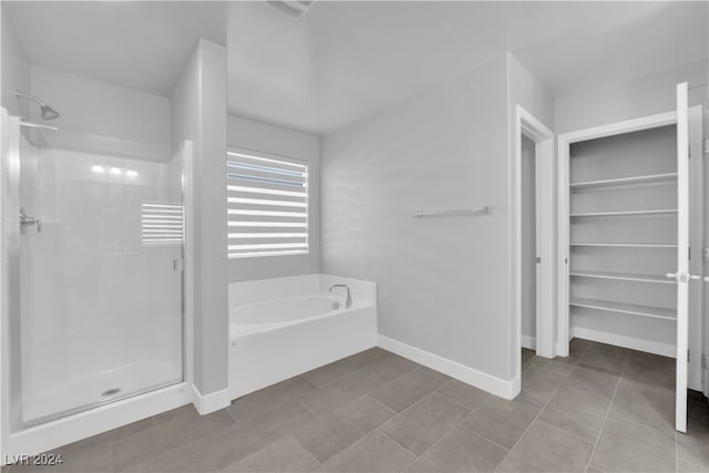 bathroom featuring tile patterned flooring and shower with separate bathtub