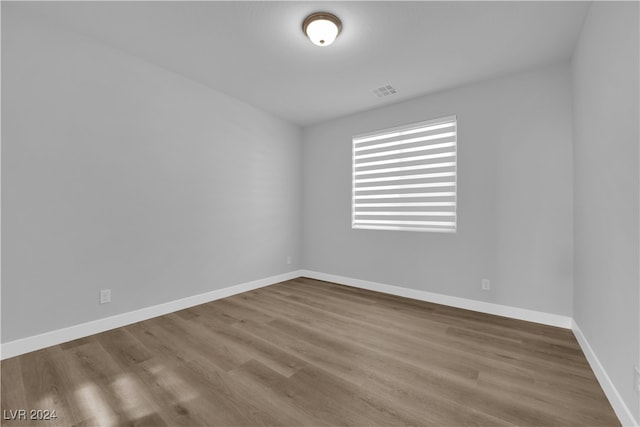 empty room with hardwood / wood-style flooring