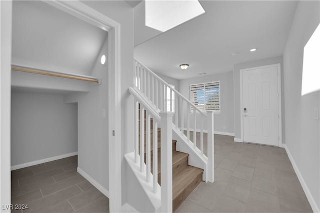 staircase featuring tile patterned floors