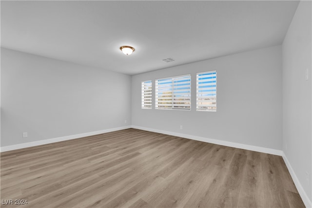 empty room with light hardwood / wood-style flooring