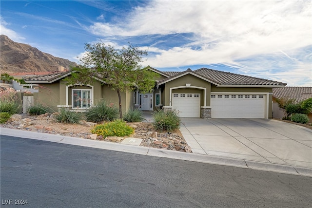 view of front of house with a mountain view and a garage