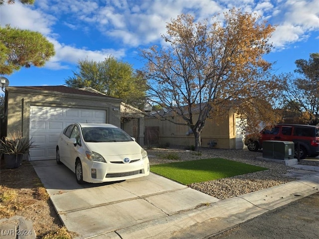 ranch-style house featuring a front yard and a garage