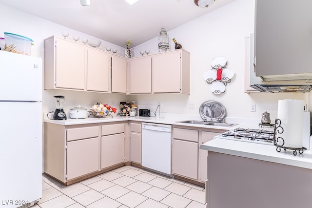 kitchen featuring white appliances, white cabinetry, lofted ceiling, and sink