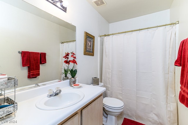 bathroom featuring tile patterned floors, vanity, and toilet