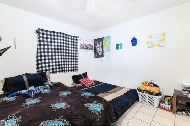 bedroom with ceiling fan and light tile patterned floors