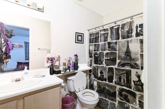 bathroom featuring a shower with curtain, vanity, and toilet