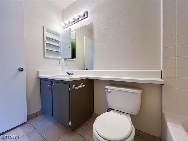 bathroom with tile patterned floors, toilet, a bathing tub, and vanity