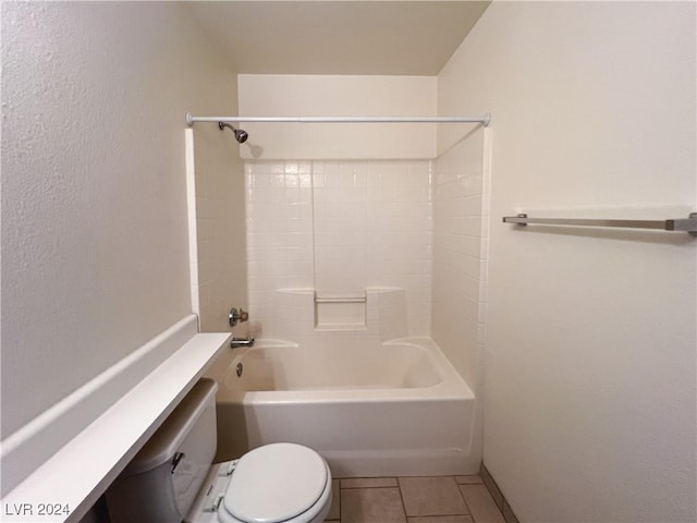 bathroom with tile patterned flooring, shower / washtub combination, and toilet