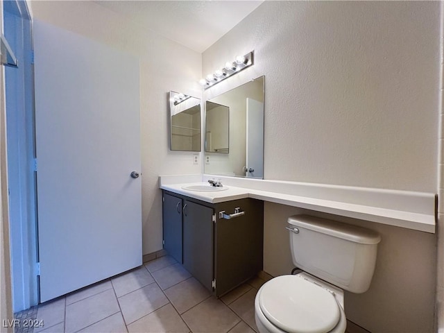 bathroom featuring vanity, tile patterned floors, and toilet