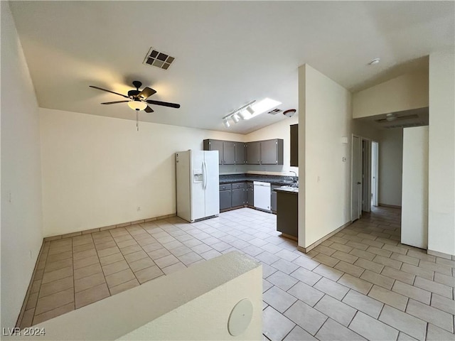 kitchen featuring lofted ceiling, white appliances, ceiling fan, and light tile patterned flooring