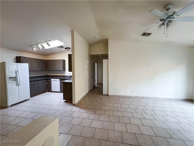 kitchen featuring vaulted ceiling, sink, light tile patterned floors, ceiling fan, and white appliances