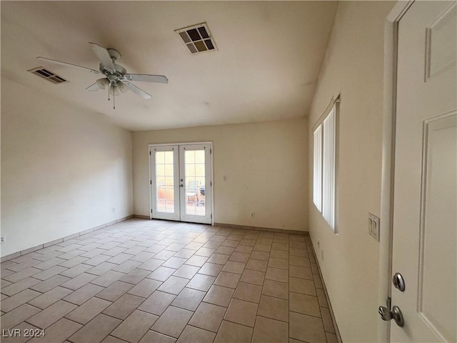 tiled empty room with french doors and ceiling fan