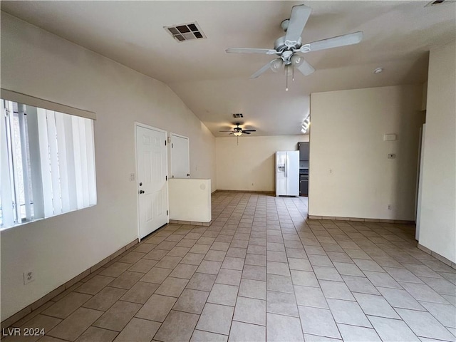 unfurnished living room with light tile patterned flooring, ceiling fan, and lofted ceiling