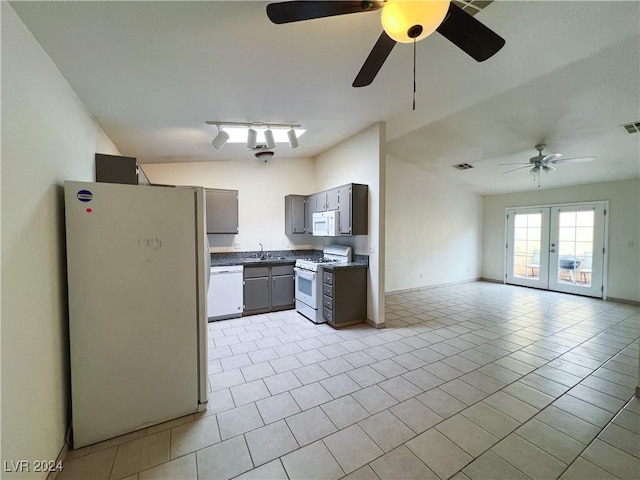 kitchen with sink, white appliances, french doors, and light tile patterned flooring