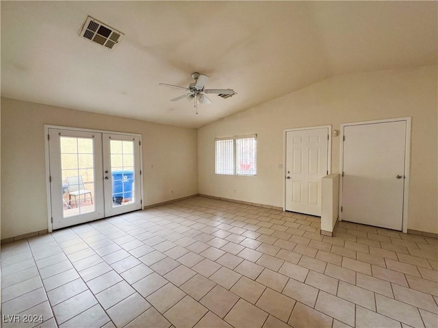 unfurnished room with vaulted ceiling, light tile patterned floors, ceiling fan, and french doors