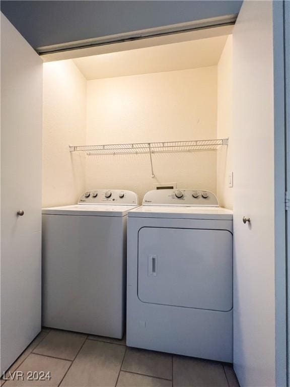 laundry area with light tile patterned floors and independent washer and dryer