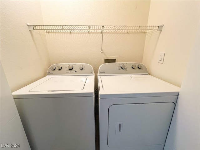 clothes washing area featuring washing machine and clothes dryer