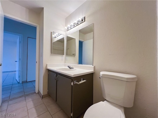 bathroom with vanity, tile patterned floors, and toilet