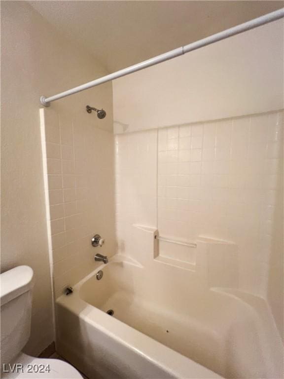 bathroom with bathing tub / shower combination and toilet