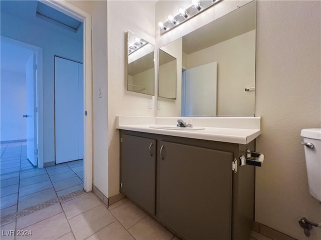 bathroom featuring tile patterned flooring, vanity, and toilet