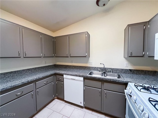 kitchen featuring sink, white appliances, light tile patterned floors, gray cabinetry, and vaulted ceiling