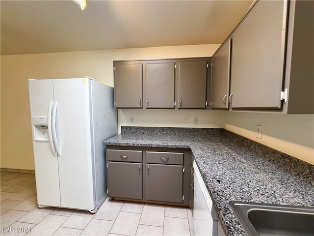 kitchen featuring white appliances and light tile patterned flooring