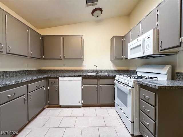 kitchen featuring white appliances, gray cabinets, and sink