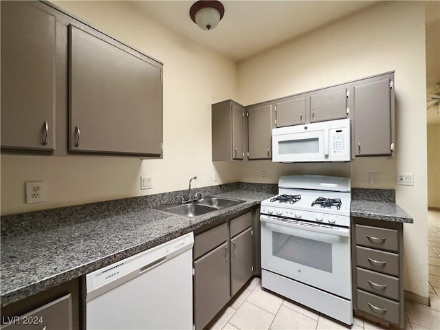 kitchen featuring sink, white appliances, and light tile patterned floors