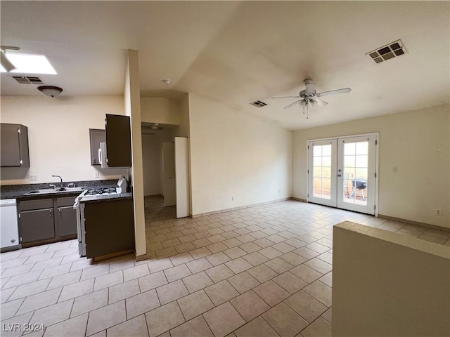 kitchen featuring sink, light tile patterned floors, ceiling fan, white appliances, and french doors