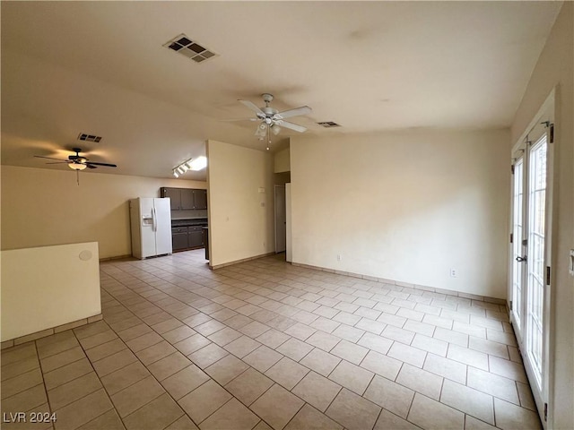 unfurnished living room with ceiling fan, lofted ceiling, and light tile patterned floors