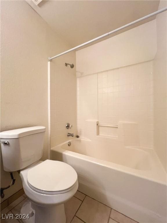 bathroom featuring shower / tub combination, tile patterned floors, and toilet