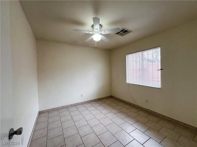 tiled empty room with ceiling fan