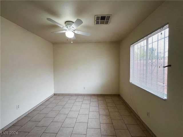 unfurnished room featuring ceiling fan and light tile patterned floors